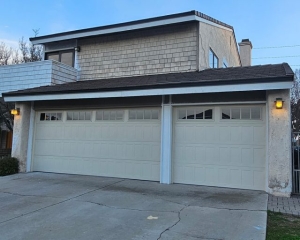 Almond stamped shaker garage doors with Madison windows installed during a home remodel in Brea, CA.
