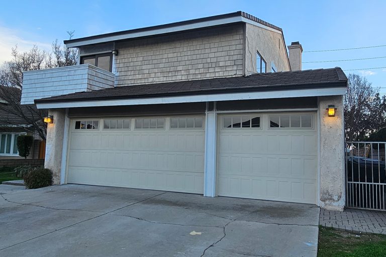 Almond stamped shaker garage doors with Madison windows installed during a home remodel in Brea, CA.