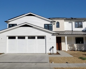 Wayne Dalton garage door with wood overlay and long panel windows installed for a new home rebuild in Newport Beach, CA.