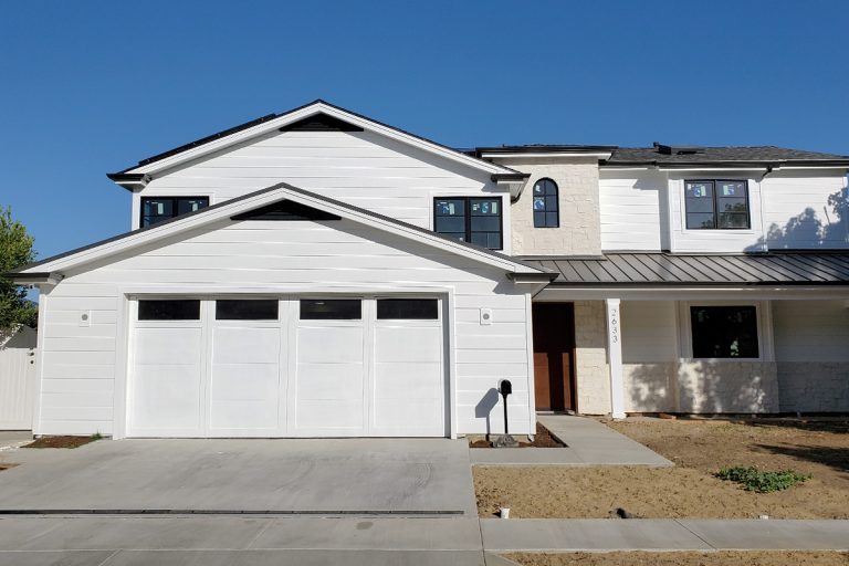 Wayne Dalton garage door with wood overlay and long panel windows installed for a new home rebuild in Newport Beach, CA.
